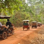 Travelling between temples at Angkor by tuk-tuk along the dusty roads during dry season