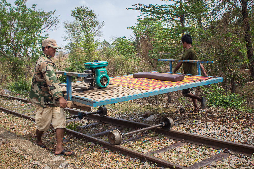 The drivers disassembling a bamboo train 