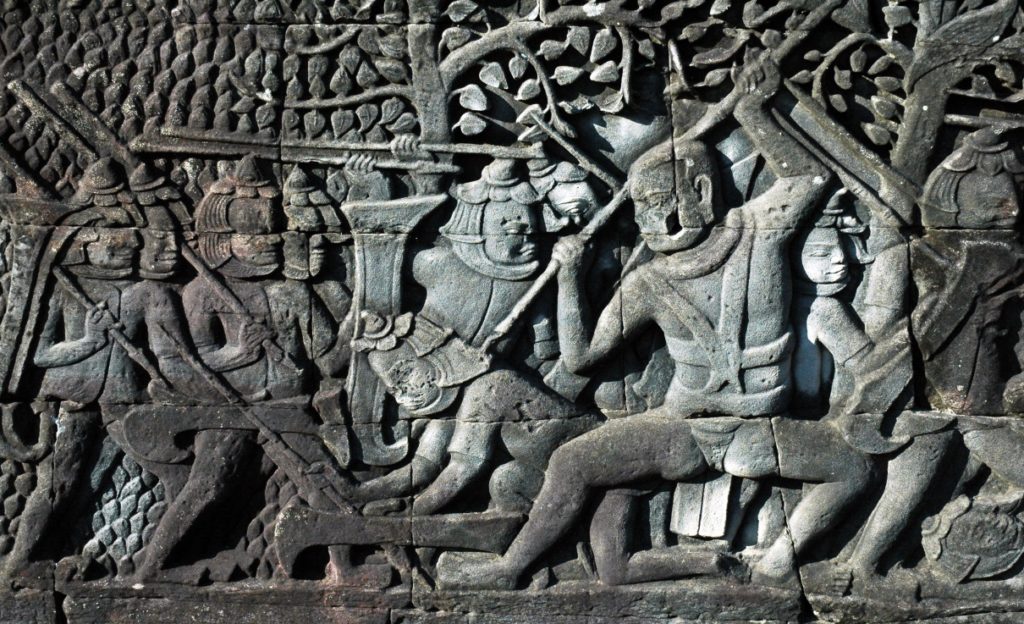 Tourists are fasinated by reliefs at Angkor Wat 